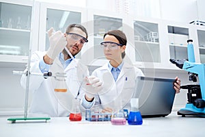 Young scientists making test or research in lab photo