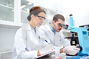 Young scientists making test or research in lab photo