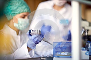 Young scientists in a protective gear work at the laboratory. Science, chemistry, lab, covid 19, virus, corona