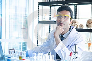 Young scientists or researchers wear eye glasses doing research in laboratory. Scientist working on computer and laboratory