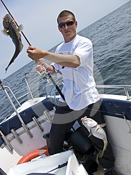 Young sea fisherman with cods