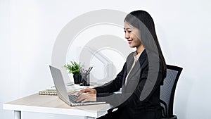 Young secretary woman checking her boss`s meeting to typing email to her boss and clients