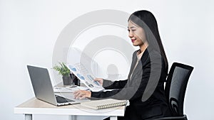 Young secretary woman holding paper document to typing email to her boss and clients