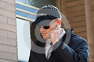 Young Security Guard Standing In Front Of The Entrance