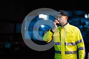 Young Security Guard Talking On Walkie-talkie