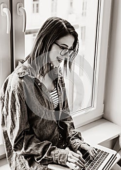 Young self-employed woman with laptop