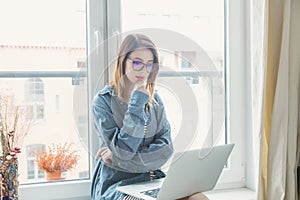 Young self-employed woman with laptop