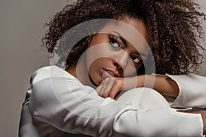 Young sensual african american woman in white shirt looking away