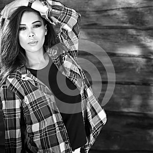 Young sensual & beauty brunette woman pose on wooden background. Black-white photo