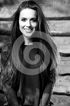 Young sensual & beauty brunette woman pose on wooden background. Black-white photo