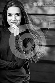 Young sensual & beauty brunette woman pose on wooden background. Black-white photo