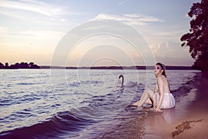 Young Sensual Sea Mermaid Blond Woman With Artistic Makeup and Strasses on Face Posing on Ocean Waves with Silver Crown And Net on