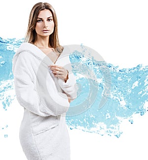 Young sensual woman in bathrobe in water splashes.