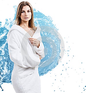 Young sensual woman in bathrobe in water splashes.