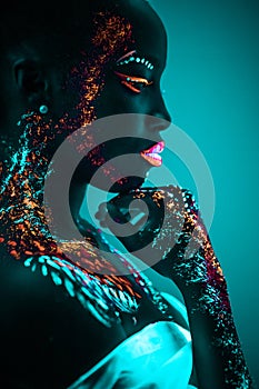 Young sensual woman in fluorescent paint makeup