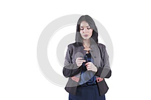 Young serious beautiful businesswoman with phone studio