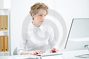 Young serious business woman with computer