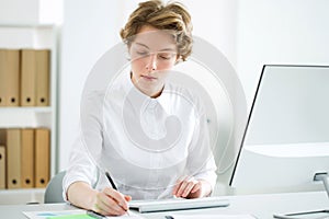 Young serious business woman with computer