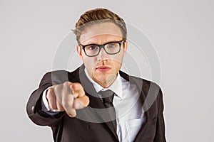 Young serious businessman pointing at camera