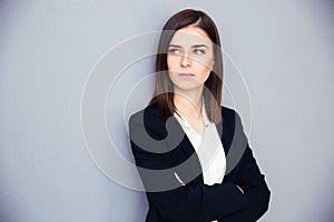 Young serious businesswoman with arms folded