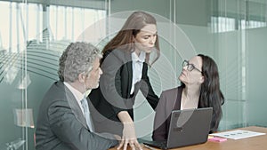 Young serious businesswoman gesturing and explaining project