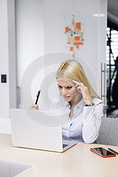 Young serious businesswoman in the office