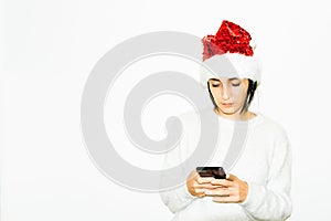 Young serious caucasian woman holds black phone isolated in white background. ns