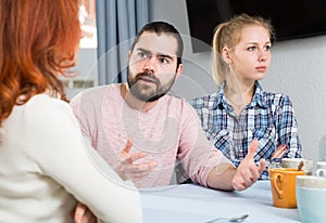 Young serious couple has a family stressful conversation at home