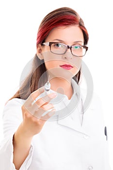 Young serious female doctor holding a syringe with needle