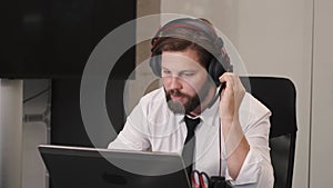 Young serious male call center operator doing his job with a headset