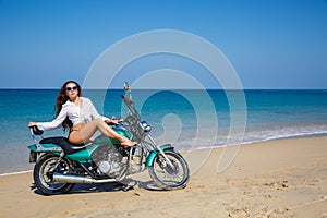 Young, sexual, the girl on the motorcycle, on a beach
