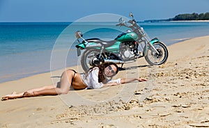 Young, sexual, the girl on the motorcycle, on a beach