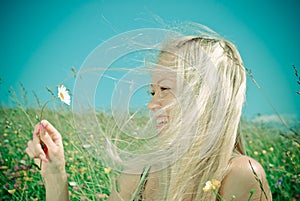 Young blonde on background of green meadow