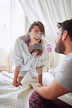 Young sexy couple in underwear having a foreplay in bed in the morinig on valentines day. Intimacy, passion, erotic concept photo