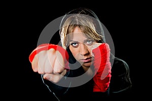 Young dangerous girl shadow boxing with wrapped hands and wrists training workout photo