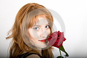 Young elegant woman with red rose