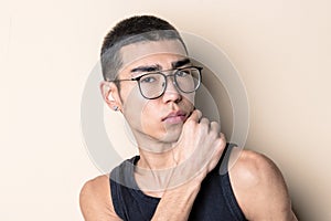 Young sexy man in glasses posing and looking at camera