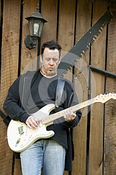 Young man singing and playing guitar