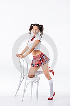 young schoolgirl with vintage white chair