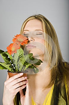 Young summer woman with orange daisy flowers