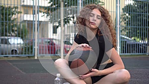 Young sexy woman with a basketball on a sports basketball court. Sports youth.