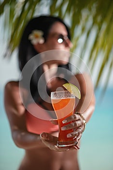 Young sexy woman with fresh drink in hands on beach, drink on exotic vacation