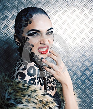 Young sexy woman with leopard make up all over body, cat bodyart print closeup