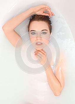 Young sexy woman relaxing in bath, top view