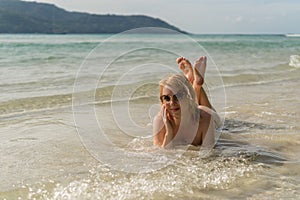 Young woman sunbathing in sea