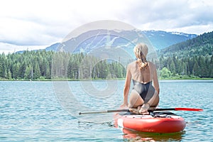 Young sexy woman swimming on stand up paddle board.Water sports , active lifestyle.