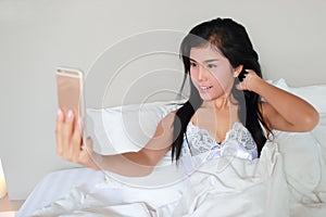 Young and sexy woman using cell phone do self portrait