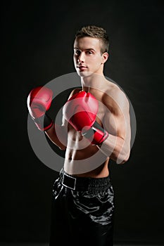 Young shaped man boxing, studio shot