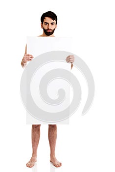 Young shirtless man holding empty banner.