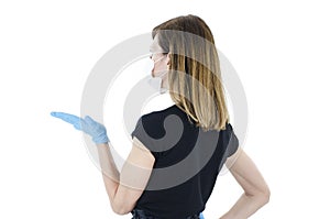 Young shocked woman with hand up. Rear view of young woman with face mask and blue gloves with hand up,